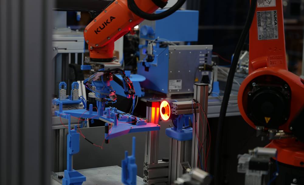 KUKA robot gripper and machine vision camera with red ring light in the Cellios wire harness assembly cell